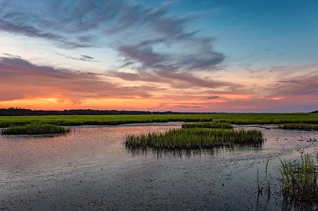 Murrells Inlet MarshWalk at sunset with string lights and marsh reflections