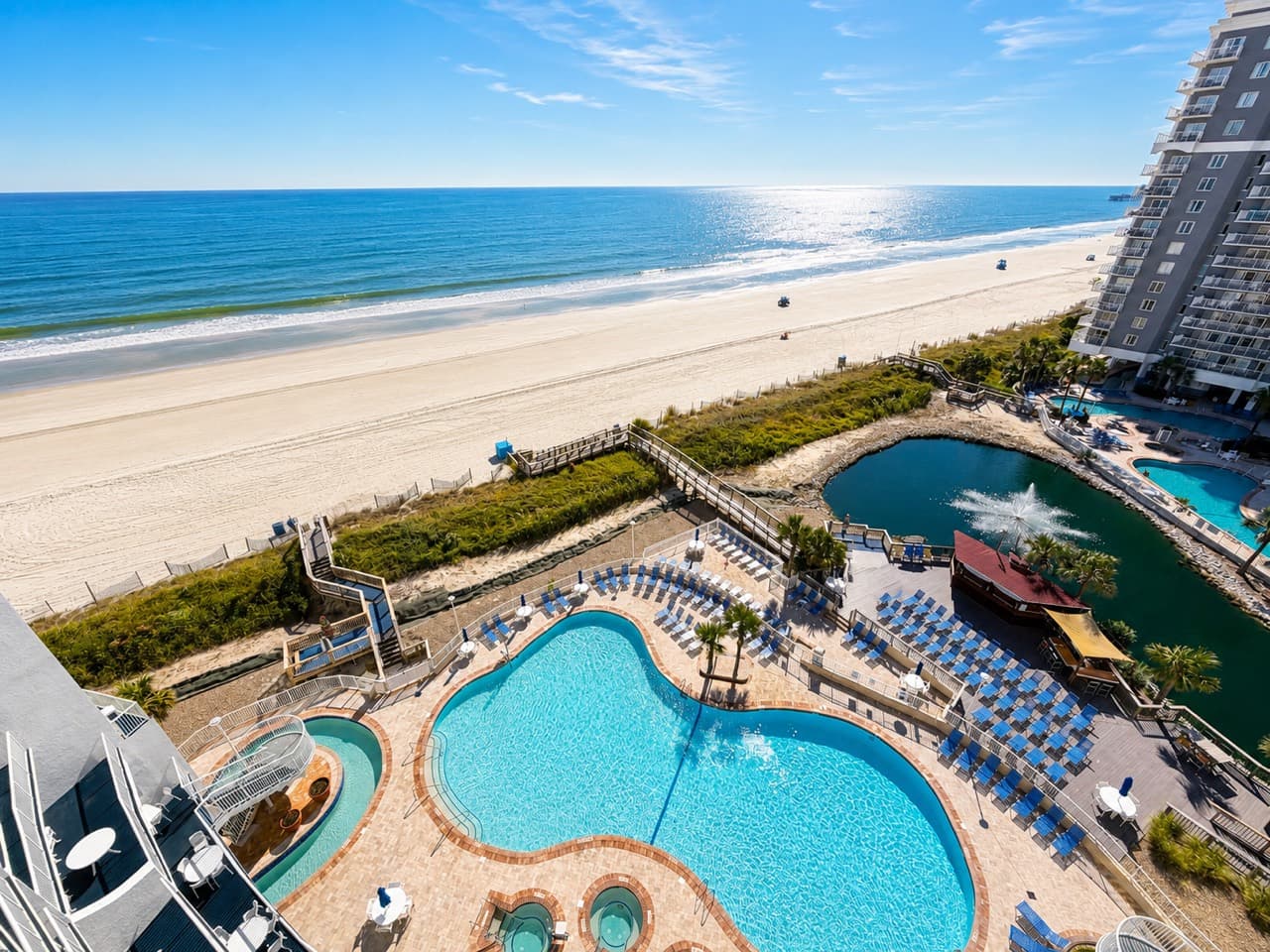 SeaWatch Resort pool deck and oceanfront view in daylight